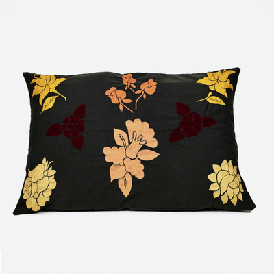 Handmade Cushion Cover with orange embroidered details.