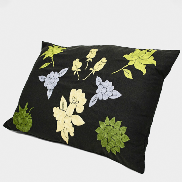 Handmade Cushion Cover with green embroidered details.